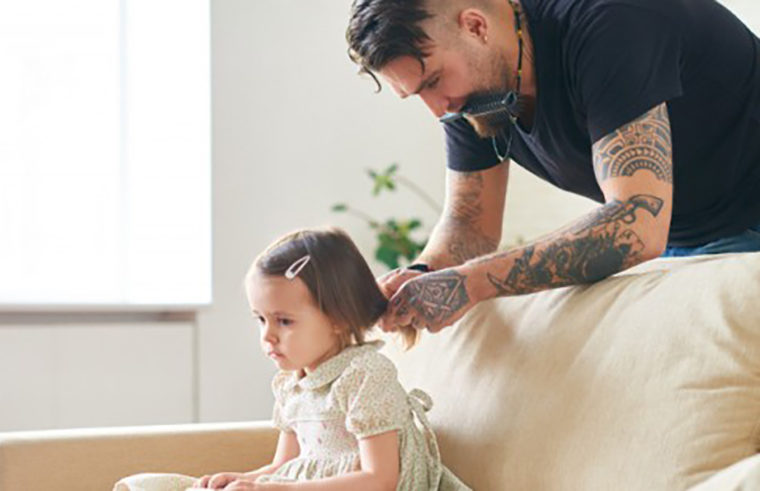 Father doing toddler girl's hair - feature
