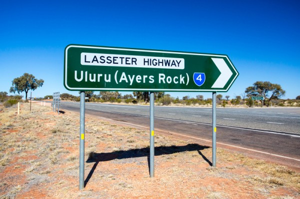 An iconic road sign directing towards Uluru on the Northern Territory, Australia