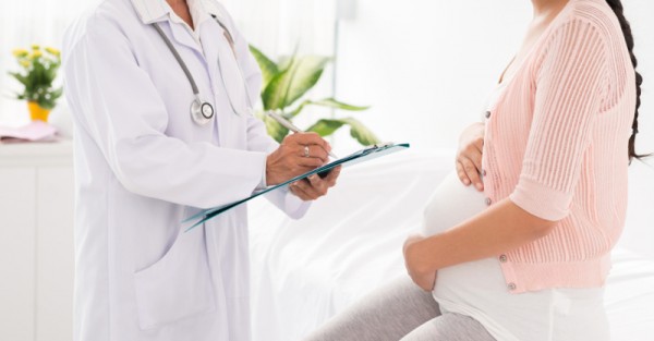 pregnant woman doctor obstetrician check up sl