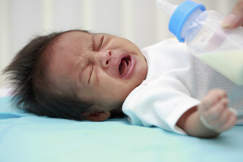 stock asian bottle feed crying newborn sl