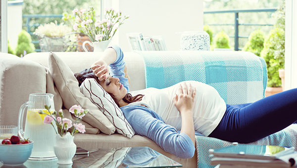 Pregnant woman lying down on the lounge