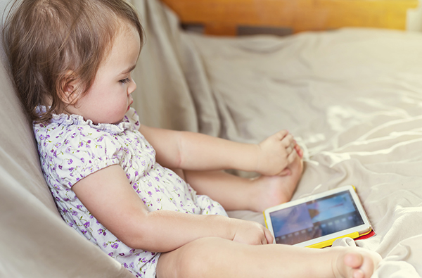 Toddler girl watching cartoons on her tablet computer