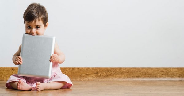 Baby holding iPad or tablet