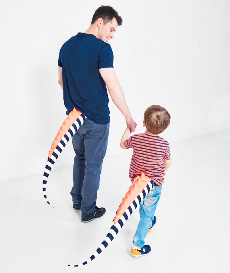 Parent and kid matching dinosaur tails
