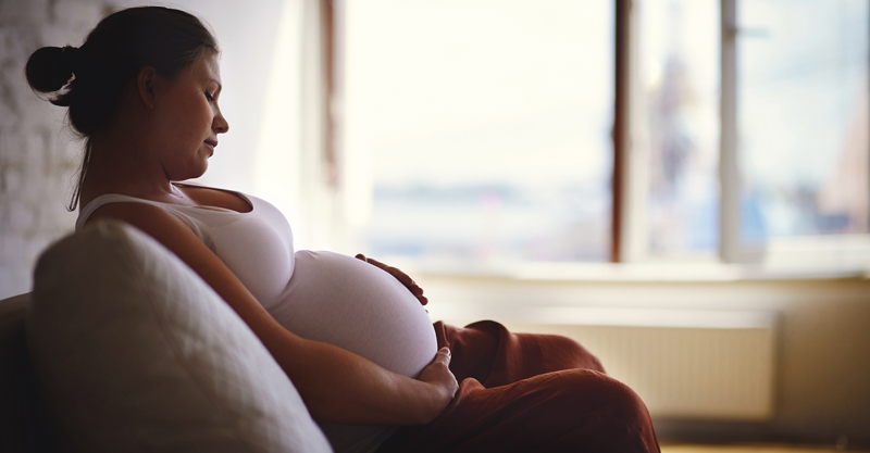 Pregnancy woman sitting on a couch