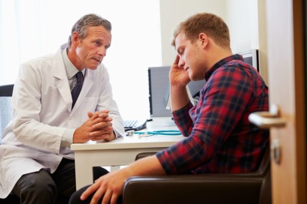 Man with depression seeking help from a doctor