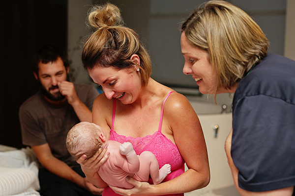 women holding newborn baby