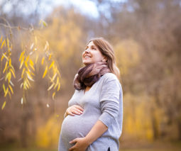 Happy pregnant woman in nature - feature