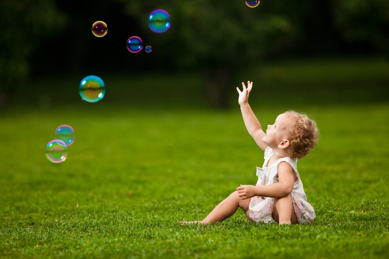 Toddler playing with bubbles