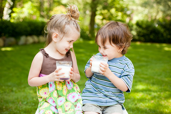 Boy and girl drinking milk