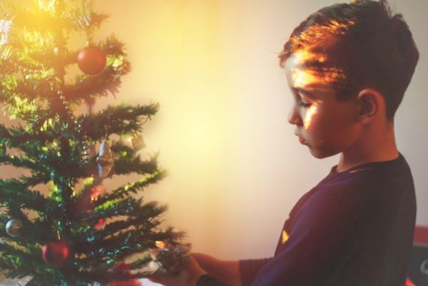 Boy decorating the Christmas tree