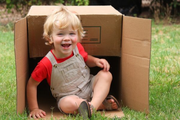 Toddler in cardboard box