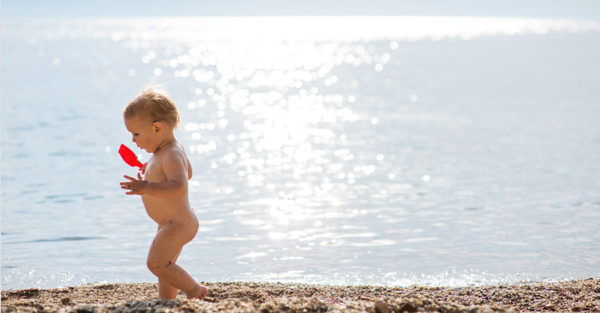 Naked Australian baby on beach