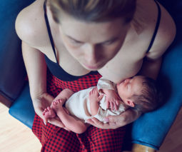 Overhead shot mother breastfeeding newborn baby - feature