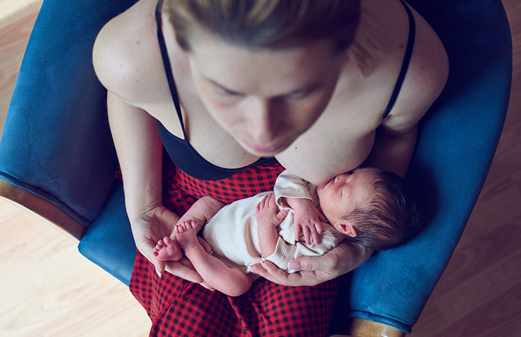 Overhead shot mother breastfeeding newborn baby - feature