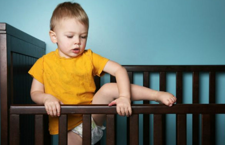 Toddler climbing out of cot