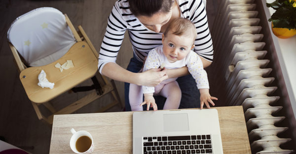 Young mother working from home with baby
