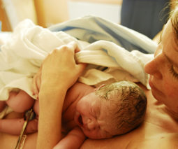 Newborn baby on mother's chest birth - feature