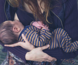 Breastfeeding baby outdoors - feature