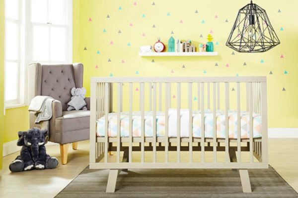 nursery with cot and yellow walls