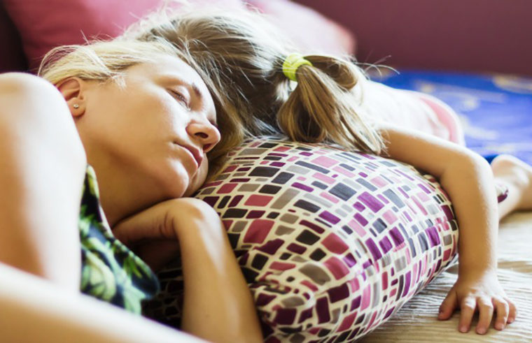 Mother and child asleep on couch - feature