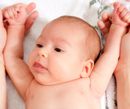 Baby lying with arms stretched above head reflex - feature