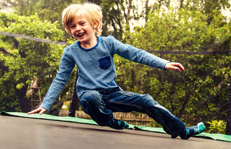 Young boy on trampoline - feature