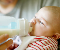Baby drinking from a bottle - feature