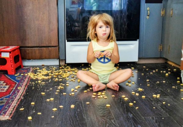 child eating food on floor