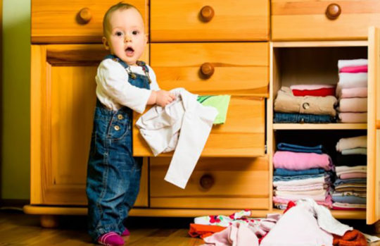 Baby pulling clothes out of drawers