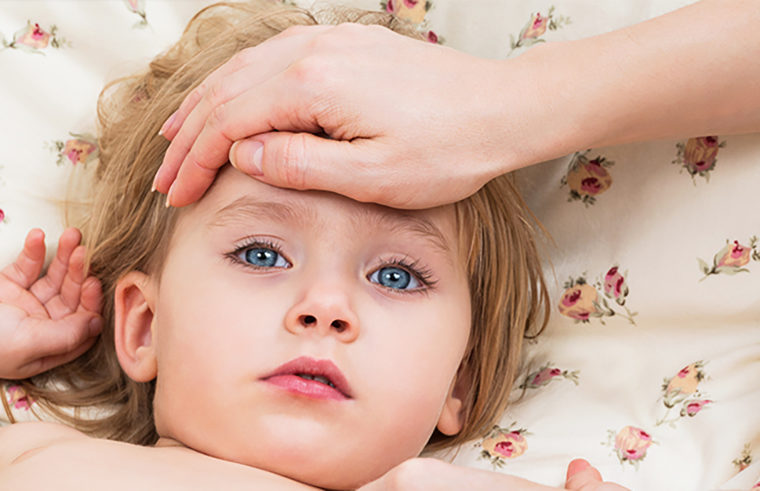 Sick child mother's hand on forehead checking temperature - feature