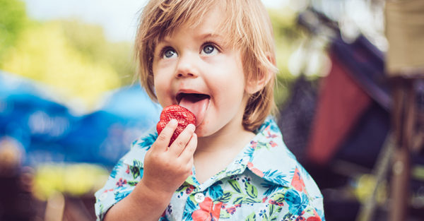 toddler eating strawberry
