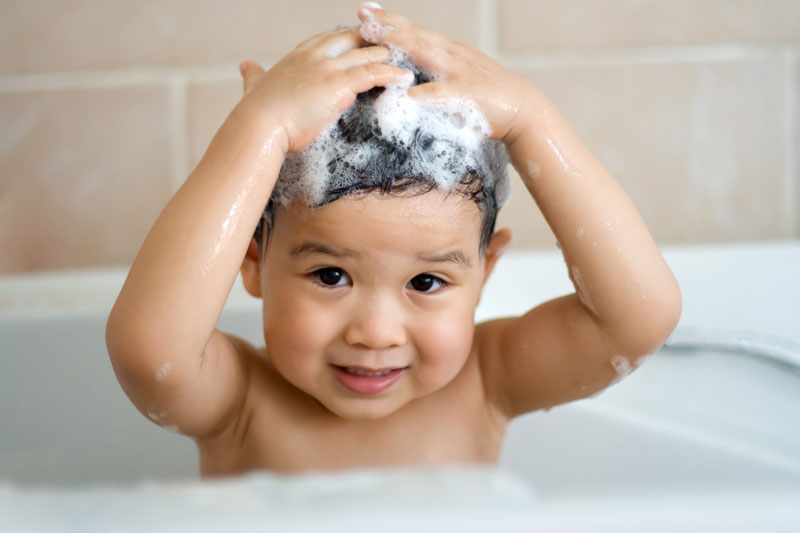 Little boy washing hair