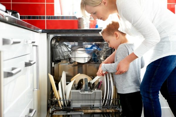 child helping with dishwasher