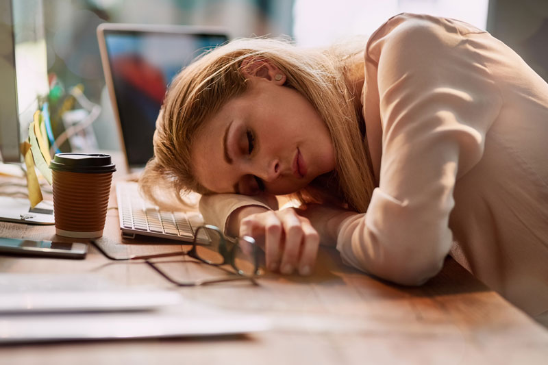 Tired woman at desk