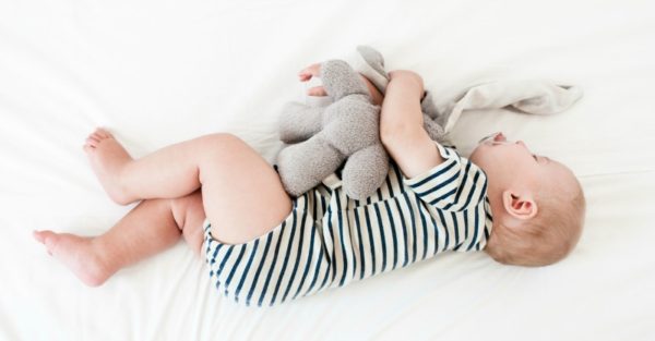 baby sleeping with soft toy