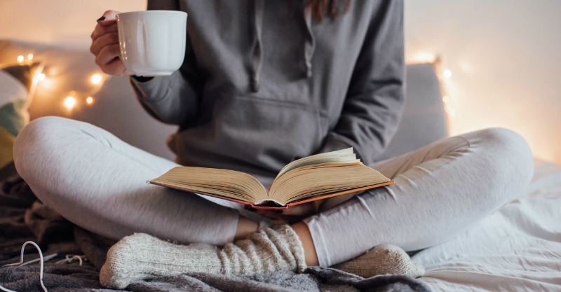 woman reading book tea