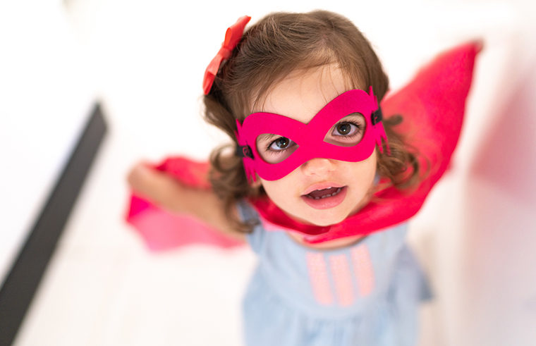 Toddler girl dressed up as superhero- feature
