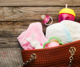 Nappy bag overflowing with baby products - feature
