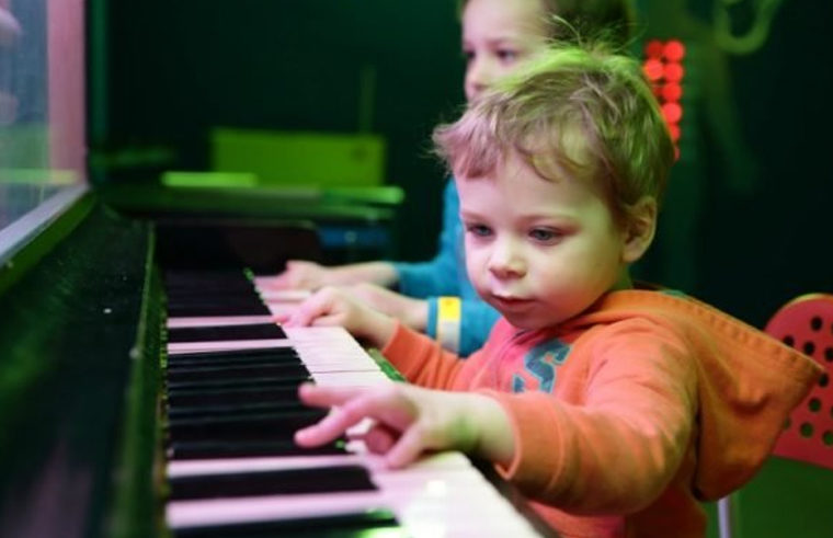 Toddler boy playing piano