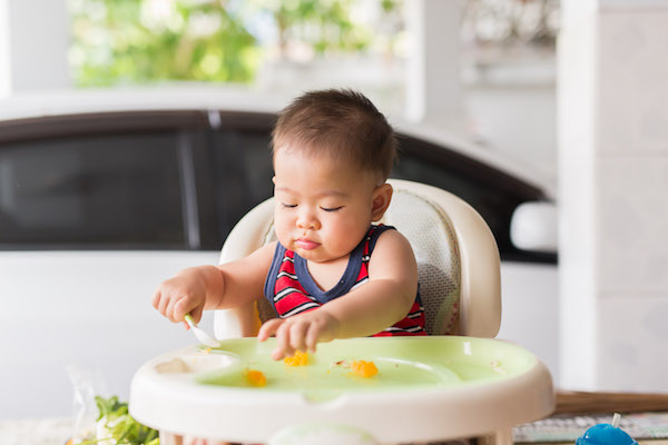 Baby eating in high chair