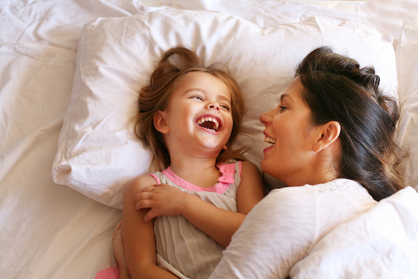 Mother and daughter / girl laughing