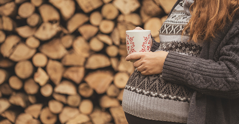 Pregnant woman drinking tea or coffee