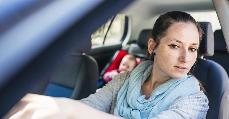 Mum driving with baby in car seat