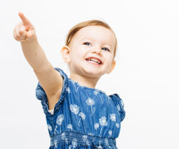 Happy toddler girl pointing - feature