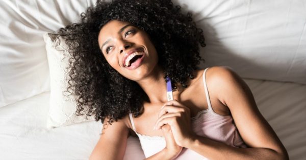 happy woman with pregnancy test
