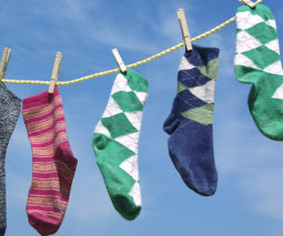 Odd socks hanging on washing line - feature