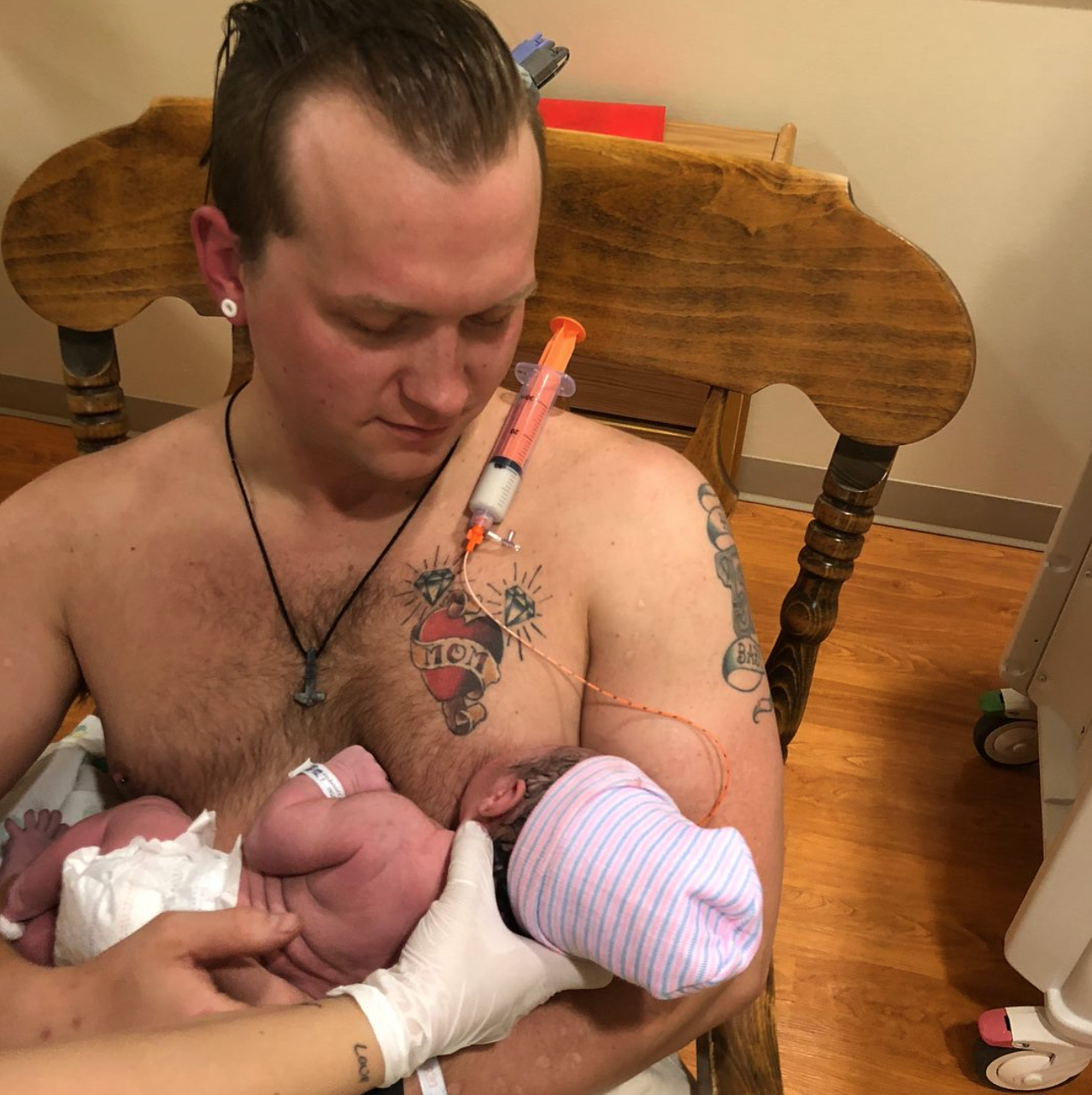 Dad breastfeeding baby