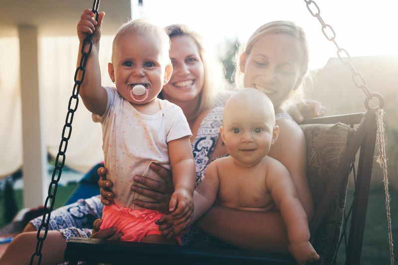 Mums with babies on outdoor swing