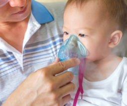 Asthmatic baby wearing oxygen mask